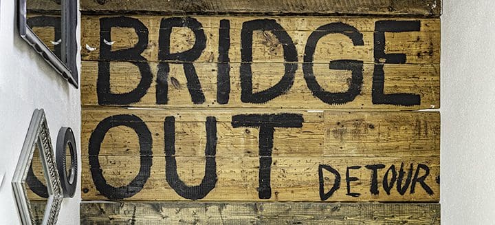 A wooden sign that says bridge out detroit.