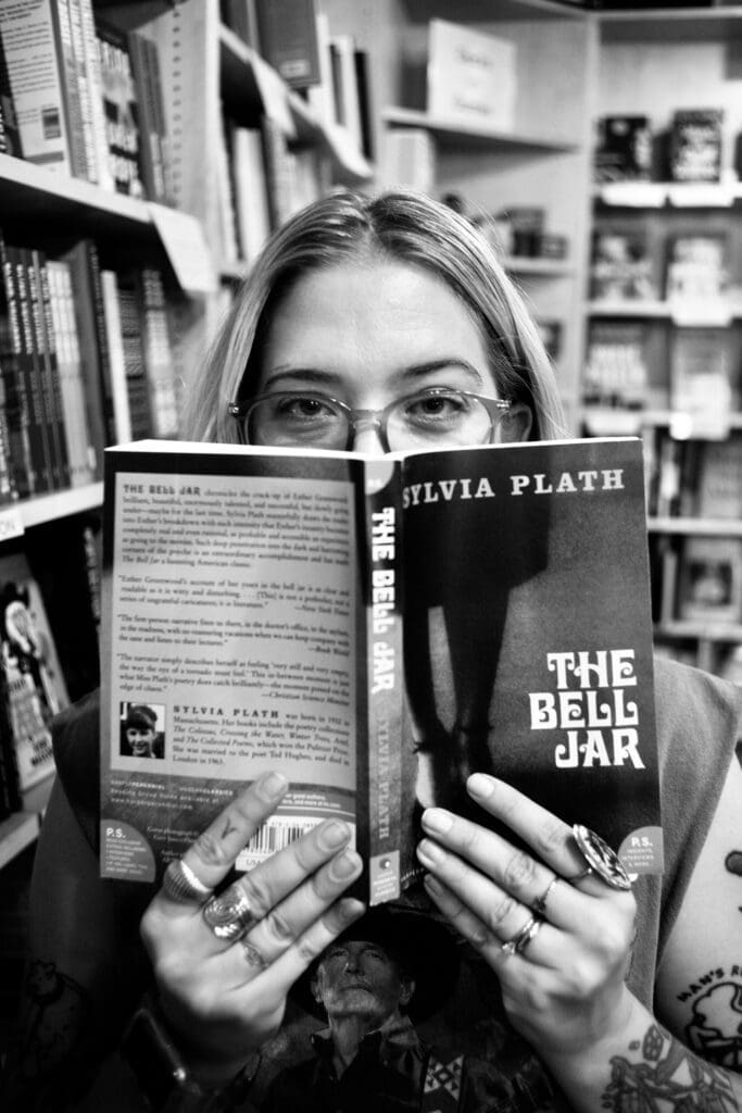 A woman is reading a book in the library.