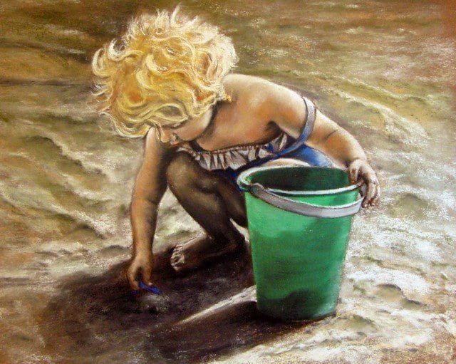 A child playing with sand and a green bucket.